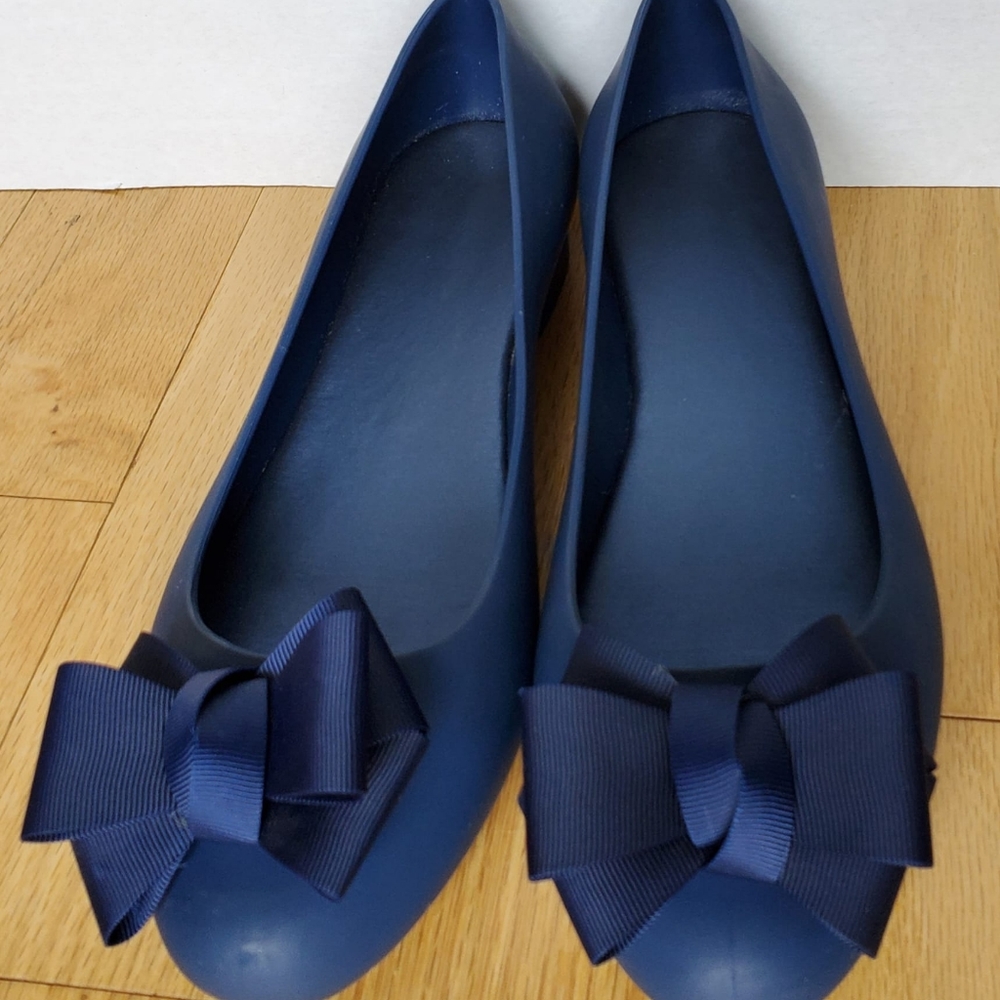 Navy blue rubber shoes with stiff grosgrain bow on toe